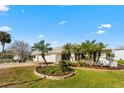 Charming single-story home with a brick driveway, two-car garage, and beautiful landscaping at 6322 Cottonwood Ln, Apollo Beach, FL 33572