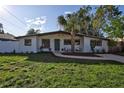 Mid-century modern home with updated exterior and landscaping at 6407 S Clark Ave, Tampa, FL 33616