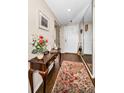 Inviting foyer with hardwood floors, console table, and mirrored closet providing ample space at 7882 Sailboat Key S Blvd # 508, South Pasadena, FL 33707
