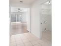Bright hallway showcasing tile floors and access to the laundry room and living space at 1009 Hardwood Dr, Valrico, FL 33596