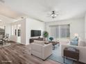 Inviting living room with wood floors, large window, and neutral decor, perfect for relaxing and entertaining at 1009 Hardwood Dr, Valrico, FL 33596