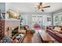 Cozy living room with a brick fireplace, large windows, and comfortable seating at 119 W Powhatan Ave, Tampa, FL 33604