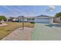 Charming one-story home with a well-manicured lawn, beautiful landscaping, and a spacious two-car garage at 1509 Blackstone Cir, Sun City Center, FL 33573