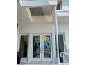 Modern front door with artistic stained glass at 1522 Gulf Blvd, Indian Rocks Beach, FL 33785