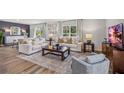 Bright and airy living room featuring modern furniture, hardwood floors and lots of natural light at 17287 Whiskey Creek Trl, Parrish, FL 34219