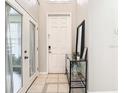 Bright foyer with a front door, mirror, and console table at 1805 Abbey Trace Dr, Dover, FL 33527