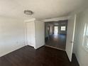 Bedroom featuring dark wood-look floors with closet and a door leading to hallway at 1817 Meridel Ave, Tampa, FL 33612