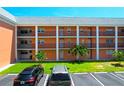 Exterior of building showcasing balconies, multiple units, parking spaces and landscaping at 1900 68Th N St # 104, St Petersburg, FL 33710