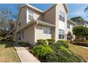 Inviting view of a two-story townhouse, showcasing the manicured front lawn at 2105 Clover Hill Rd, Palm Harbor, FL 34683