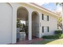 Multi-Gathering exterior featuring stucco arches, black shutters, and a well-maintained lawn at 2207 S Carolina Ave # 16, Tampa, FL 33629
