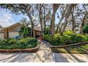 Beautifully landscaped front yard enhances the curb appeal of this lovely home at 3089 Enisglen Dr, Palm Harbor, FL 34683