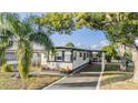 Charming single-story home with a covered carport and landscaped front yard at 37321 8Th Ave, Zephyrhills, FL 33542