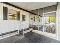 Enclosed patio features screened windows and sliding glass door at 37321 8Th Ave, Zephyrhills, FL 33542