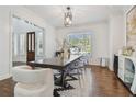 Bright dining room with table, clear chairs, decorative light fixture, and modern decor at 4610 W Browning Ave, Tampa, FL 33629