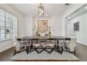 Dining room showcasing table with clear chairs, a modern chandelier, and a stylish rug at 4610 W Browning Ave, Tampa, FL 33629