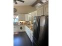 Modern kitchen with granite countertops, stainless steel appliances, and dark wood flooring at 5086 Barrington Cir # 3201, Sarasota, FL 34234