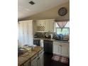 Well-appointed kitchen featuring granite countertops, wine storage, and stainless steel appliances at 5086 Barrington Cir # 3201, Sarasota, FL 34234