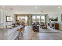 Open-concept living room featuring modern decor, ample natural light, and a view to the outside at 5636 Silver Moonlight Dr, Palmetto, FL 34221