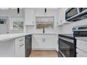 Modern kitchen featuring white cabinets, stainless steel appliances, and a breakfast bar at 6326 22Nd N Ave, St Petersburg, FL 33710