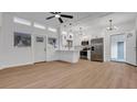 Bright, open-concept living room with white walls, ceiling fan, hardwood floors and kitchen at 6326 22Nd N Ave, St Petersburg, FL 33710