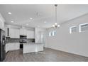 Open-concept kitchen features sleek stainless steel appliances and stylish gray backsplash at 724 Winterside Dr, Apollo Beach, FL 33572