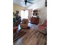 Cozy living room features wood-look floors, recliner seating and unique decorative elements at 7608 Chenkin, Zephyrhills, FL 33540