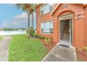 Exterior shot of a home featuring a view of the lake, palm trees, and a staircase at 9204 Lake Chase Island Way # 9204, Tampa, FL 33626