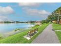 Scenic lakeside view with a bench, fountain, and walking path enhancing the community's appeal at 9204 Lake Chase Island Way # 9204, Tampa, FL 33626