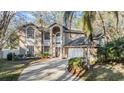 Two story home featuring an arched entryway, large windows, a two car garage and manicured landscaping at 9318 Heritage Oak Ct, Tampa, FL 33647