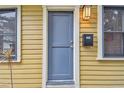 Charming blue front door detail with address, stylish exterior light and fresh landscaping at 1045 6Th N St, St Petersburg, FL 33701