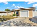 Well-maintained single-Gathering home featuring lush green lawn and attached one car garage at 1721 S Jefferson Ave, Clearwater, FL 33756