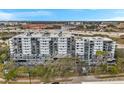 A low aerial shot of the building showing the balconies and mature landscaping at 201 W Laurel St # 909, Tampa, FL 33602