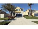 Charming two-story home featuring a spacious two-car garage and well-manicured lawn at 21211 Southern Charm Dr, Land O Lakes, FL 34637