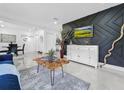 Modern living room with accent wall, tiled floors, and natural wood coffee table at 2522 W North St, Tampa, FL 33614