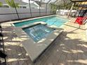 Inviting screened-in pool featuring a spa with brick pavers at 3600 105Th N Ave, Clearwater, FL 33762