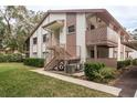 A charming condo building featuring a staircase entry and lush greenery, offering a blend of comfort and style at 515 Mistletoe Ct # C, Safety Harbor, FL 34695