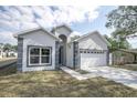 Charming single-Gathering home with an attached garage and freshly cut lawn at 5341 71St N Way, St Petersburg, FL 33709