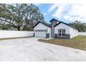 The house features a two car garage, concrete driveway and manicured yard at 5351 71St N Way, St Petersburg, FL 33709