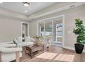 Bright living room featuring neutral tones, wood floors, and a sliding glass door to the patio at 5361 71St N Way, St Petersburg, FL 33709