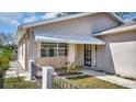 A quaint covered front porch with decorative railing and security gate provides a welcoming entrance at 7048 68Th N St, Pinellas Park, FL 33781