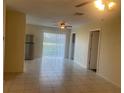 Open-concept living area with tile floors, ceiling fan, and sliding glass doors to the outside at 8969 109Th Ter, Seminole, FL 33777