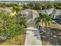 Overhead view of a beautiful house showcasing the roof, driveway, and verdant surrounding trees at 918 Regal Manor Way, Sun City Center, FL 33573