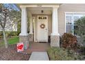 Charming home entrance with decorative wreath, stone accents, and manicured garden at 12402 Country White Cir, Tampa, FL 33635