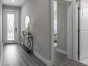 Inviting entryway with a decorative mirror, sleek console table, and modern flooring at 1409 W Wood St, Tampa, FL 33604