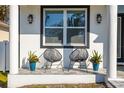 Cozy front porch featuring stylish seating, decorative plants, and elegant lighting fixtures at 1409 W Wood St, Tampa, FL 33604