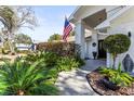 Landscaped front yard with decorative plants leading up to the front door at 18836 Autumn Lake Blvd, Hudson, FL 34667