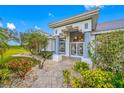 Charming home entrance with landscaped walkway and decorative front door at 2011 Captiva Ct, Sun City Center, FL 33573