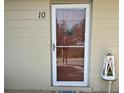 Close up of the front door of the home with glass paneling, and the number 10 on the house at 2330 Ecuadorian Way # 10, Clearwater, FL 33763