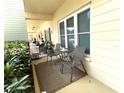 A cozy patio setup with chairs and table outside of the unit with small plants at 2330 Ecuadorian Way # 10, Clearwater, FL 33763