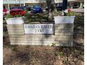 A flower-lined monument sign for Hawaiian Towers, located at 2330 at 2330 Ecuadorian Way # 10, Clearwater, FL 33763